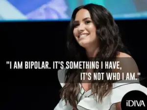 Against a vibrant backdrop, a woman with long dark hair in an off-the-shoulder top smiles softly. Text reads: "I am bipolar. It's something I have, it's not who I am." Highlighting mental health awareness, the iDIVA logo rests in the corner.